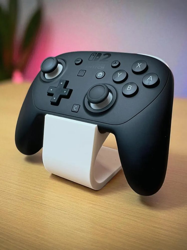 Curved controller stand holding a game controller on a desk